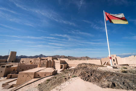 Bahla, Oman, December 30, 2019: Panoramic of the beautiful fortress with the flag of Oman wavingのeditorial素材
