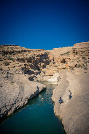 Wadi Bani Khalid, Oman, January 2, 2020: People bathing in the canyon on a sunny dayのeditorial素材
