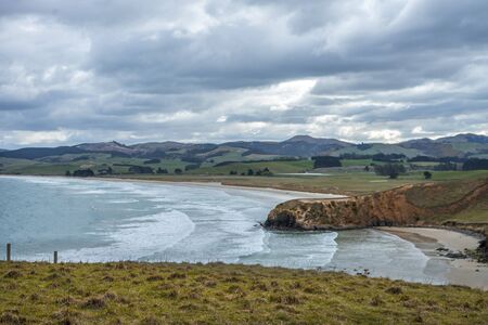 Stunning panorama of a cliff in Dunedin taken on a cloudy day, New Zealandの写真素材
