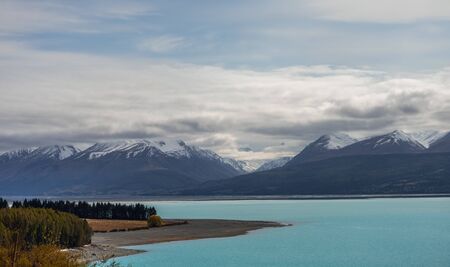 Beautiful view of the bluish Pukaki Lake with snowy Mount Cook in the background, New Zealandの写真素材