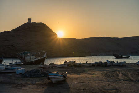 Boats stranded with Al Ayjah castle in the background at Sur's bay, Omanのeditorial素材