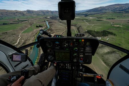 Impressive image of a helicopter cabin with the city of Wanaka in the background on a sunny winter day, New Zealandの写真素材