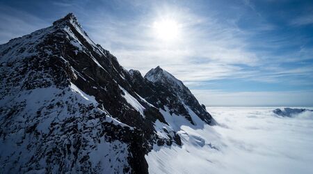 Wonderful picture of the snowy Mount Aspiring with the sea of â€‹â€‹clouds below and the...