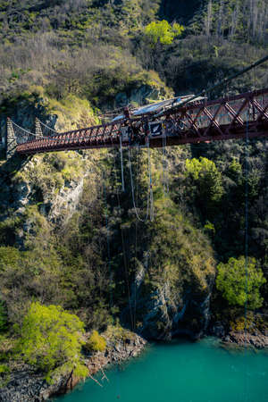 Kawarau Bridge, New Zealand, October 6, 2019: Modern European boy preparing to bungee jump with the New Zealand flag at his sideのeditorial素材