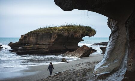 Truman Track, New Zealand,  October 8, 2019: Beautiful image of blonde European girl walking on a...