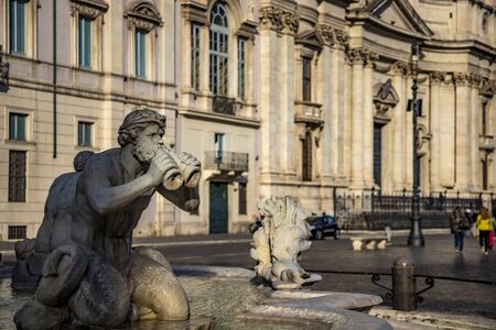 The Fontana del Moro, sculpted by Giacomo della Porta, in Piazza Navona, the ancient Stadium of Domitian, in Rome, Italy. Church of Sant'Agnese in Agone in the background.の写真素材