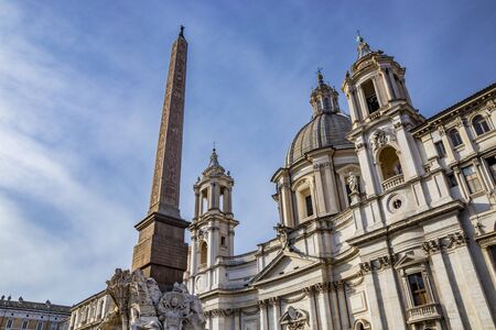 The Fountain of the Four Rivers designed in 1651 by Gian Lorenzo Bernini for Pope Innocent X, in Piazza Navona, ancient Stadium of Domitian, in Rome, Italy. Church of Sant'Agnese in Agone background.の写真素材