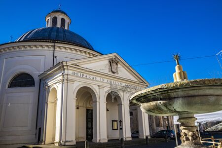 the church of Santa Maria Assunta, in the monumental Piazza di Corte, by Gian Lorenzo Bernini and the Chigi family. The dome, the bell tower and the fountain. Ariccia, Castelli Romani, Lazio, Italy.の写真素材