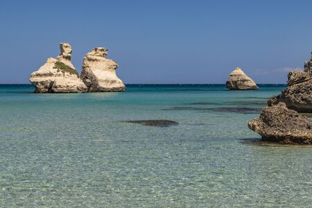 The bay of Torre dell'Orso, with its high cliffs, in Salento, Puglia, Italy. Turquoise sea and blue...