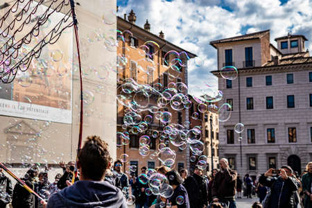 November 18, 2018 - Rome, Italy - Beautiful show of soap bubbles, for the enjoyment of many children and parents. In Piazza Navona, the ancient Stadium of Domitian. happy people admire the show.のeditorial素材