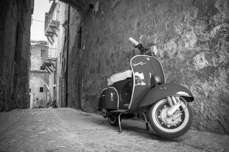 June 30, 2019 - Rome, Lazio, Italy - A Piaggio Vespa Sprint, parked in an alleyway of an ancient village, in Italy. The scooter symbol of Italian design.のeditorial素材