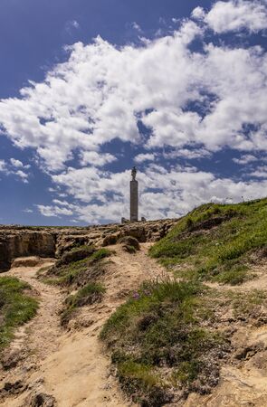 The important archaeological site and tourist resort of Roca Vecchia, in Puglia, Salento, Italy. blue sky, rocks, sun, lush vegetation in summer. The column of Santa Maria di Rocaの写真素材