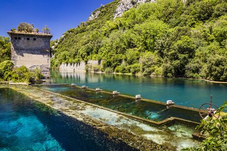 The Roman port of ancient Narnia (Narni), in Stifone, in the canyons of the Nera river. The blue sky and the clear, cold and turquoise water, on a sunny day, in the summer. Wild and pristine nature. の写真素材