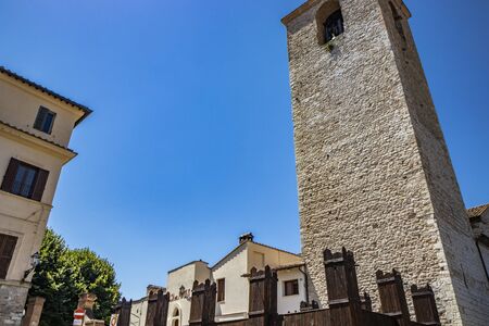 A medieval tower in the ancient village of Narni, with old stone and brick buildings. Umbria, Terni, Italy. The blue sky on a summer day.の写真素材