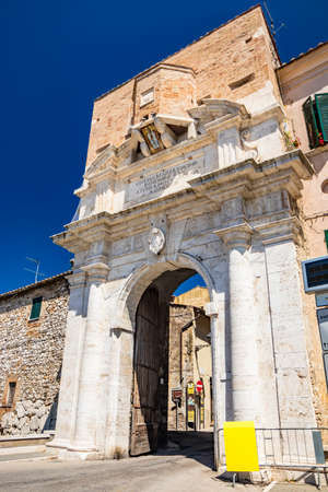 June 30, 2019 - Amelia, Umbria, Terni, Italy - Ancient Roman gate, entrance to the city of Amelia, in Umbria. Arch and columns in travertine, stone, brick and marble.のeditorial素材