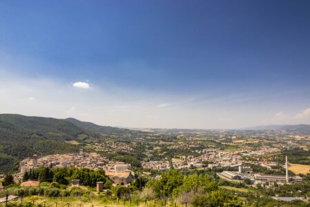 View from above of the ancient medieval village of Narni. Umbria, Terni, Italy. The view of the mountains, the trees, the nature. The red roofs of the houses, the bell towers of the churches.の写真素材