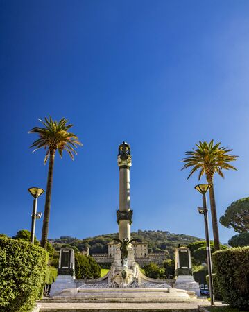 Monument to the Fallen of the War, in Piazza Guglielmo Marconi. Bronze statue of Winged Victory, large column and fountain with water jet. Frascati, Rome, Lazio, Italy, Roman Castlesの写真素材
