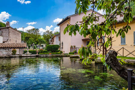 June 2, 2019 - Foligno, Umbria, Italy - The small village of Rasiglia, crossed by many streams and waterfalls, fed by the Menotre river. A large tank (cistern) for collecting water. Old brick houses.のeditorial素材