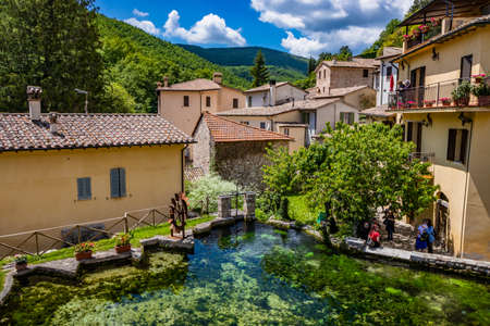 June 2, 2019 - Foligno, Umbria, Italy - The small village of Rasiglia, crossed by many streams and waterfalls, fed by the Menotre river. A large tank (cistern) for collecting water. Old brick houses.のeditorial素材