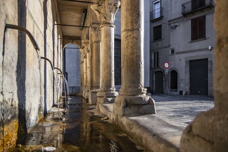 The "Fontana Fraterna" is the monumental public fountain symbol of the city of Isernia. Columns and round arches. Built with blocks of stone of Roman origin. Drinking water flows from 6 spouts.の写真素材