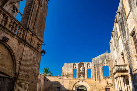 The courtyard of the castle, or ducal palace, of the Castromediano Lymburgh, in Cavallino, Lecce, Puglia, Salento, Italy. Empty windows and niches with stone statues.のeditorial素材