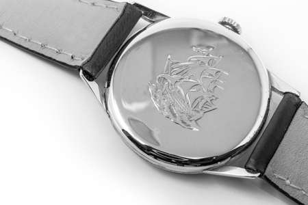 November 5, 2019 - Rome, Italy - An old Longines gold mechanical wristwatch with manual winding. Antique watch ruined by time. On the back of the watch case the engraving of a sailing ship. Spend timeのeditorial素材