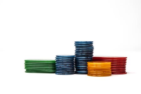 Stack of chips, isolated on white background. Colors: orange, blue, green, red. Betting, winning and...