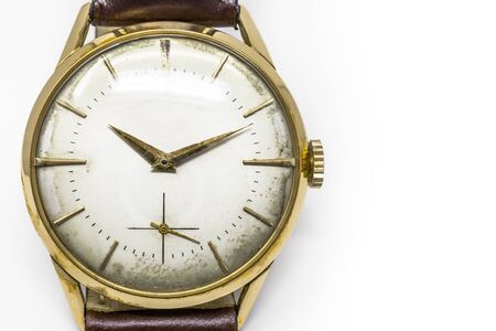 An old gold mechanical wristwatch with manual winding. Antique watch ruined by time, with scratches...