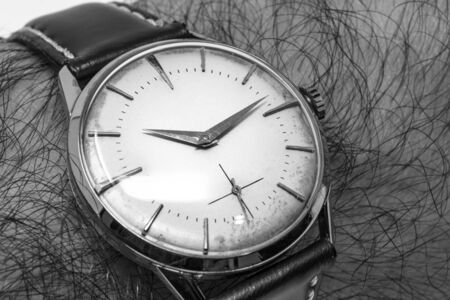 An old gold mechanical wristwatch with manual winding. Antique watch ruined by time, with scratches...