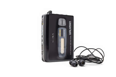 March 5, 2019 - Rome, Lazio, Italy - The original sony walkman, vintage portable cassette player, icon and symbol of the 80s and 90s. headphones isolated on white background.のeditorial素材