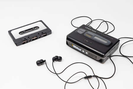 March 5, 2019 - Rome, Lazio, Italy - The original sony walkman, vintage portable cassette player, icon and symbol of the 80s and 90s. Blank audio tape and headphones isolated on white background.のeditorial素材