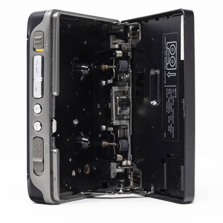 Vintage audio player. Old fashioned portable cassette player, cult object, icon and symbol of the 80s and 90s. Isolated on white background. Open door.の写真素材
