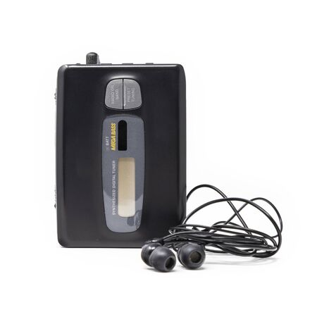 Vintage audio player. Old fashioned portable cassette player, cult object, icon and symbol of the 80s and 90s. Headphones isolated on white background.の写真素材