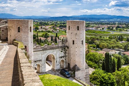 The Porta di Venere, from the Roman era, made of white travertine, with its three arches and the two towers of Properzio. In Spello, province of Perugia, Umbria, Italy.の写真素材