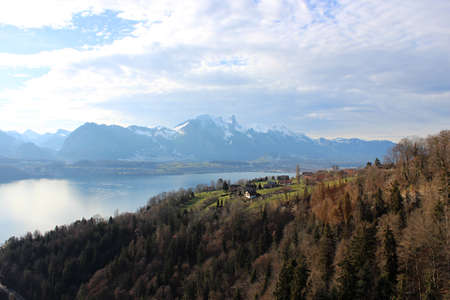 View of the lake, among the snow-capped mountains, in winter. Lake Thun is a lake in the canton of Bern in Switzerland, in the city of Thun. It is a natural lake formed by the river Aare.の写真素材