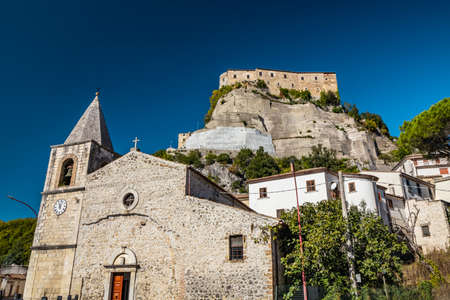 A view of the ancient village of Cerro al Volturno. The Pandone castle stands on top of the hill, on a rock spur. The town church with the bell tower and the clock. Isernia, Molise, Italy.のeditorial素材