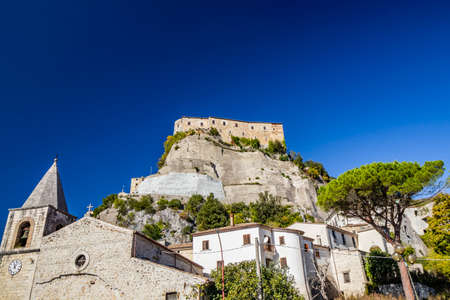 A view of the ancient village of Cerro al Volturno. The Pandone castle stands on top of the hill, on a rock spur. The town church with the bell tower and the clock. Isernia, Molise, Italy.のeditorial素材