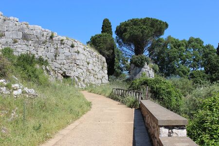 Archaeological site of the ancient city of Norba Latina, in the province of Latina, Lazio, Italy. The remains of stone walls and cobblestone streets.の写真素材