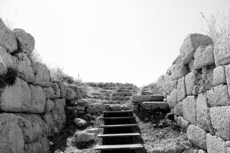 Archaeological site of the ancient city of Norba Latina, in the province of Latina, Lazio, Italy. The remains of stone walls and cobblestone streets.の写真素材