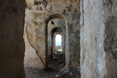 The Temple of Jupiter, Mount Circeo, in Terracina, Lazio, Italy. The remains of the temple on the top of the mountain and the view of the city and the sea from above. The blue sky on summer day.の写真素材