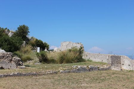 The Temple of Jupiter, Mount Circeo, in Terracina, Lazio, Italy. The remains of the temple on the top of the mountain and the view of the city and the sea from above. The blue sky on summer day.の写真素材