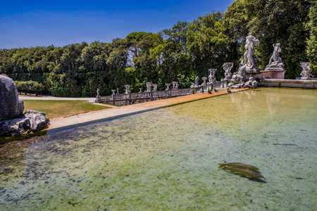 July 3, 2020 - Royal Palace of (Reggia di) Caserta - The huge and very long basin of the park's artificial lake. The perspective view, towards the waterfall and the numerous pools and water features.のeditorial素材