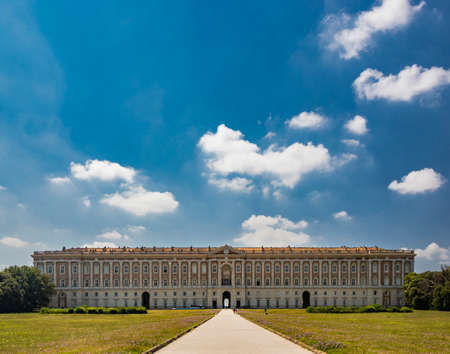 July 3, 2020 - Royal Palace of (Reggia di) Caserta - The very long basin of the park's artificial lake. The perspective view. The marble statues look and extend their hand towards the palace. Blue skyのeditorial素材