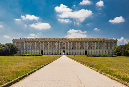 July 3, 2020 - Royal Palace of (Reggia di) Caserta - The very long basin of the park's artificial lake. The perspective view. The marble statues look and extend their hand towards the palace. Blue skyのeditorial素材