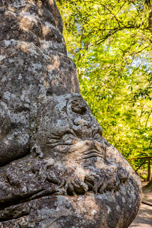 June 28, 2020 - Sacro Bosco (Sacred Grove) or Park of the Monsters of Bomarzo - Mannerist monumental garden. The struggle of the two giants Ercole and Caco. Close up of the suffering face of Caco.のeditorial素材