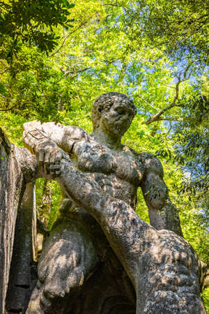 June 28, 2020 - Sacro Bosco (Sacred Grove) or Park of the Monsters of Bomarzo - Mannerist monumental garden. Echidna is a colossal woman with two snake tails instead of legs. Two lions.のeditorial素材