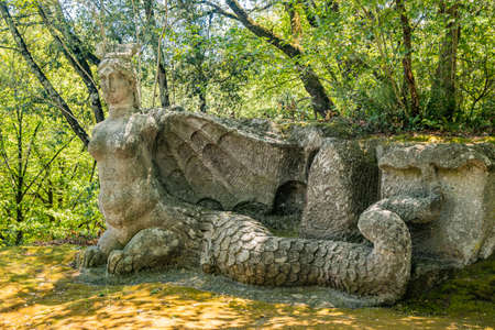 June 28, 2020 - Sacro Bosco (Sacred Grove) or Park of the Monsters of Bomarzo - Mannerist monumental garden. The Fury is a woman with a dolphin tail and dragon wings.のeditorial素材