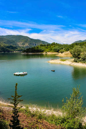 The lake of Salto, the largest artificial lake in Lazio, located in the province of Rieti and created in 1940 by damming the Salto river with the Salto dam. Small boats and pedal boats for bathers.の写真素材