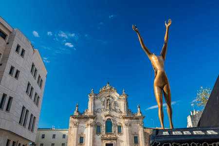 August 8, 2020 - Matera, Basilicata, Italy - The church of San Francesco d'Assisi, in Baroque style. Salvador DalÃ¬'s sculpture: the Dancing Piano. Woman with arms raised to the sky.のeditorial素材