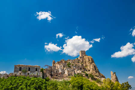 Craco, Matera, Basilicata, Italy. The ghost town destroyed and abandoned following a landslide. View of the remains and ruins of the ancient village built on the top of the hill. Watchtower at the topのeditorial素材